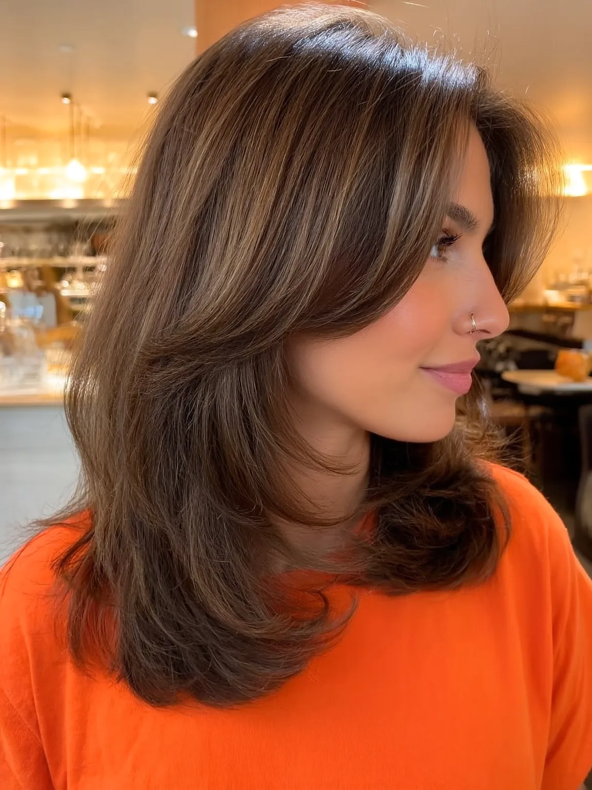 Shoulder-Length Warm Caramel Waves with Curtain Bangs